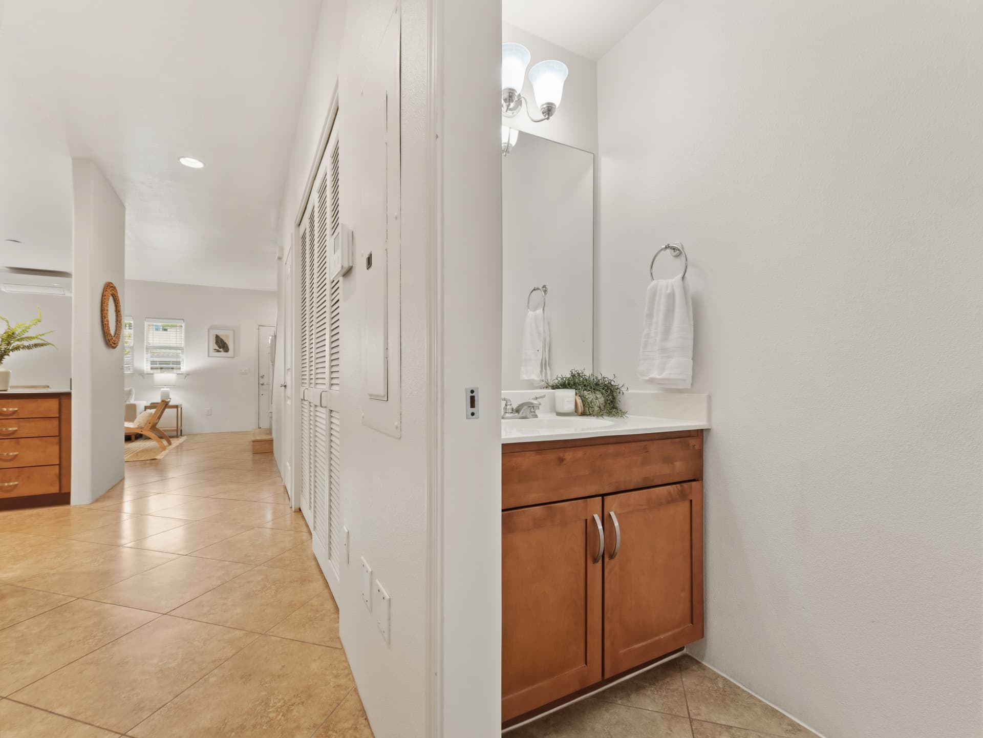 Downstairs half bath vanity off the entry hallway