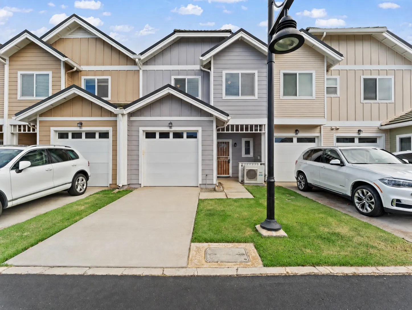 Townhome exterior with single-car garage and driveway parking