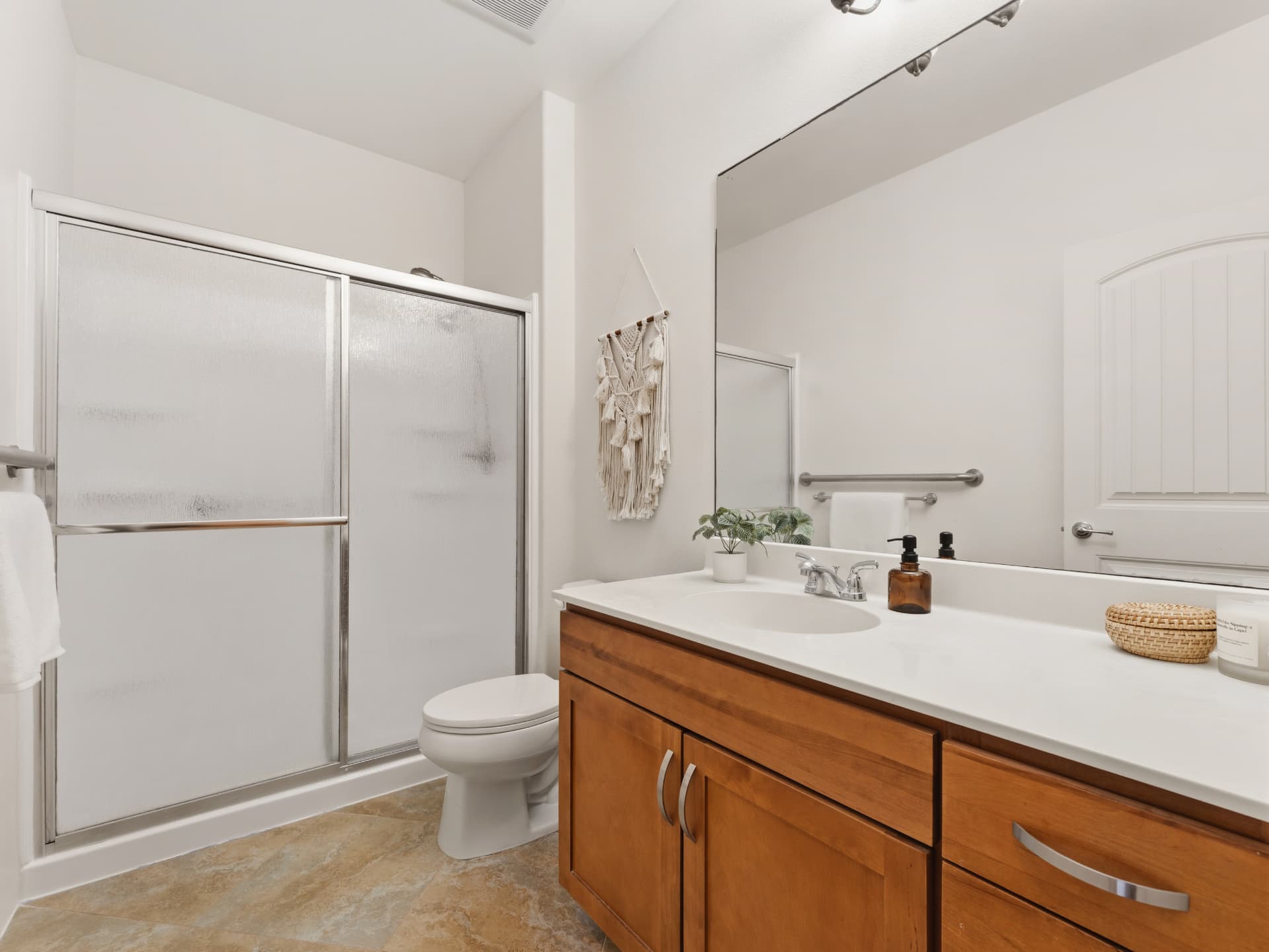 Full bathroom with walk-in shower, wood vanity and large mirror