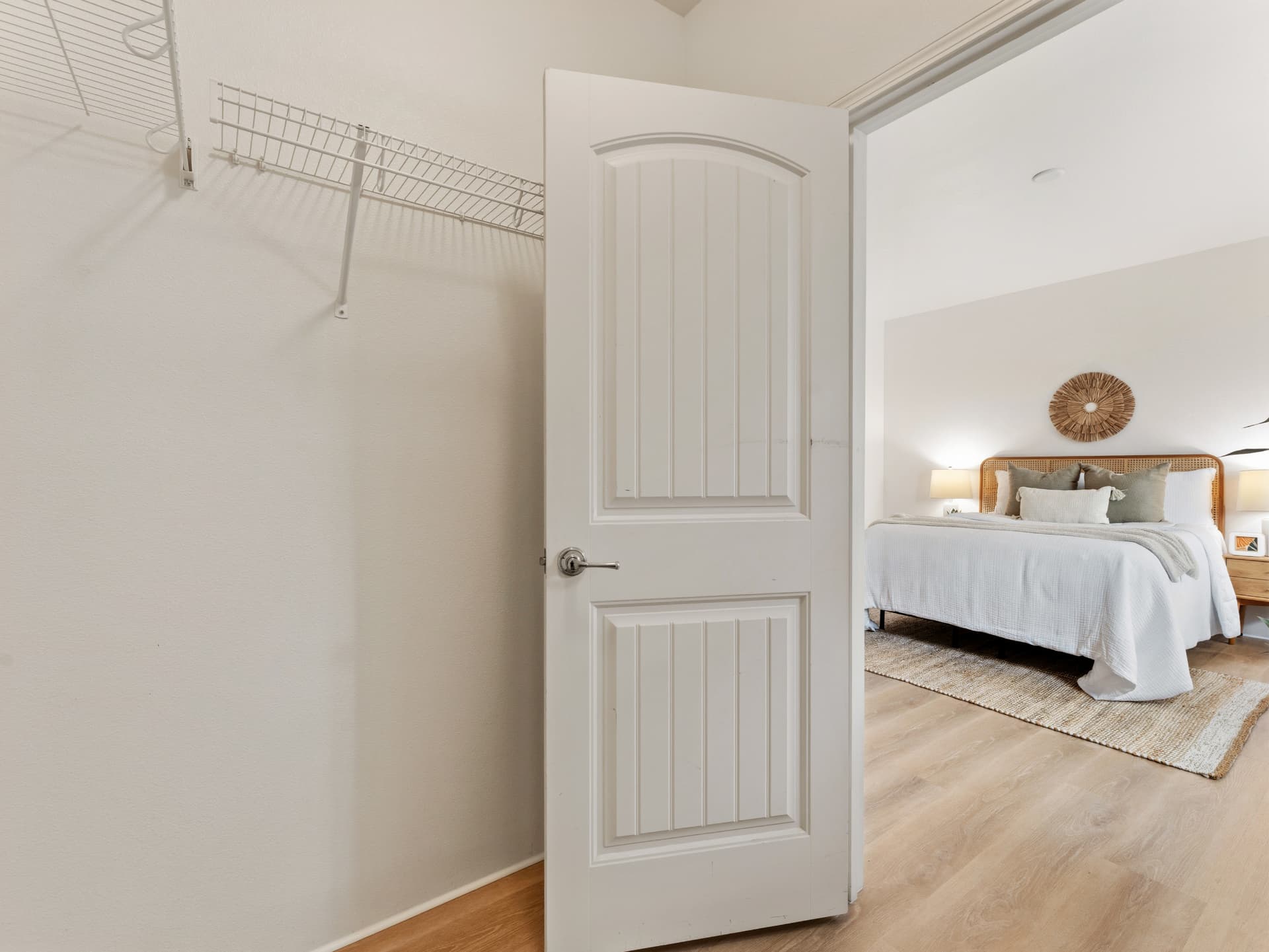 Primary suite walk-in closet with shelving
