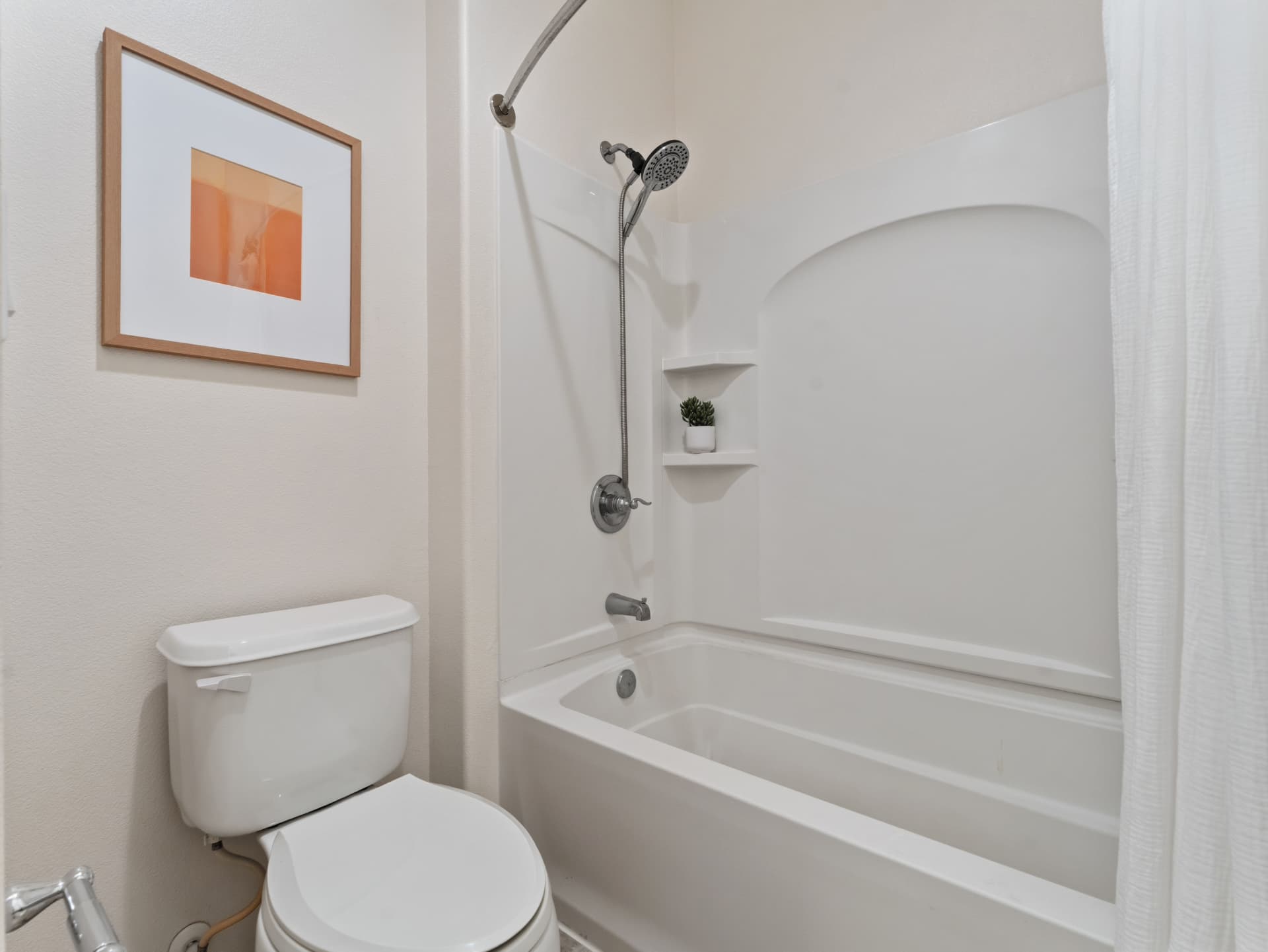 Reglazed tub and shower with toilet in the full bath
