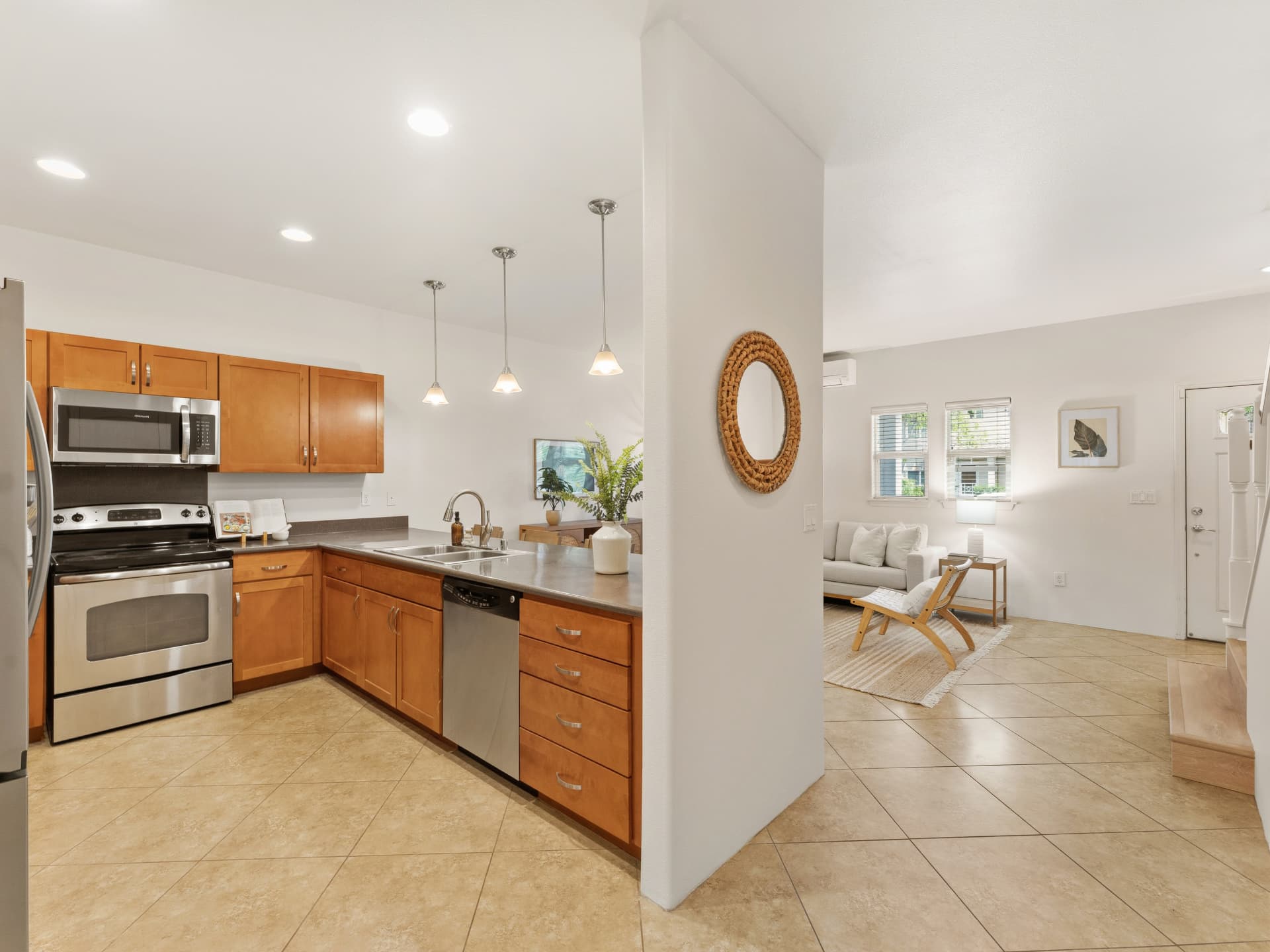 Kitchen open to the entry and living room with tile flooring