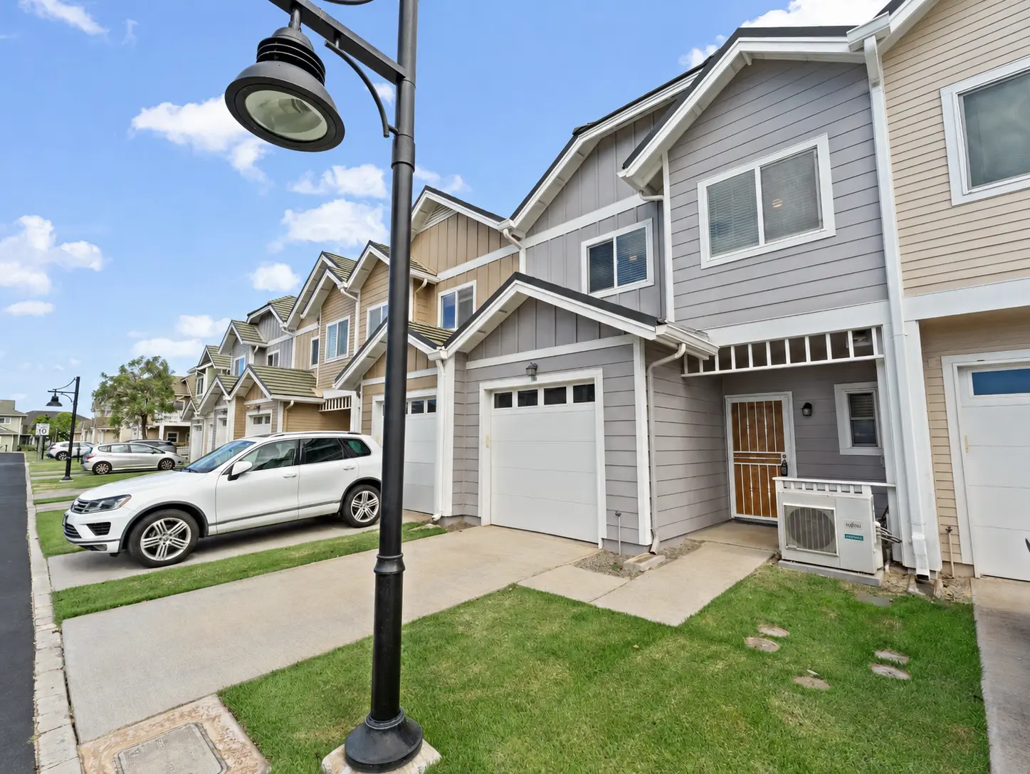 Street view of the townhome row with garage and driveway