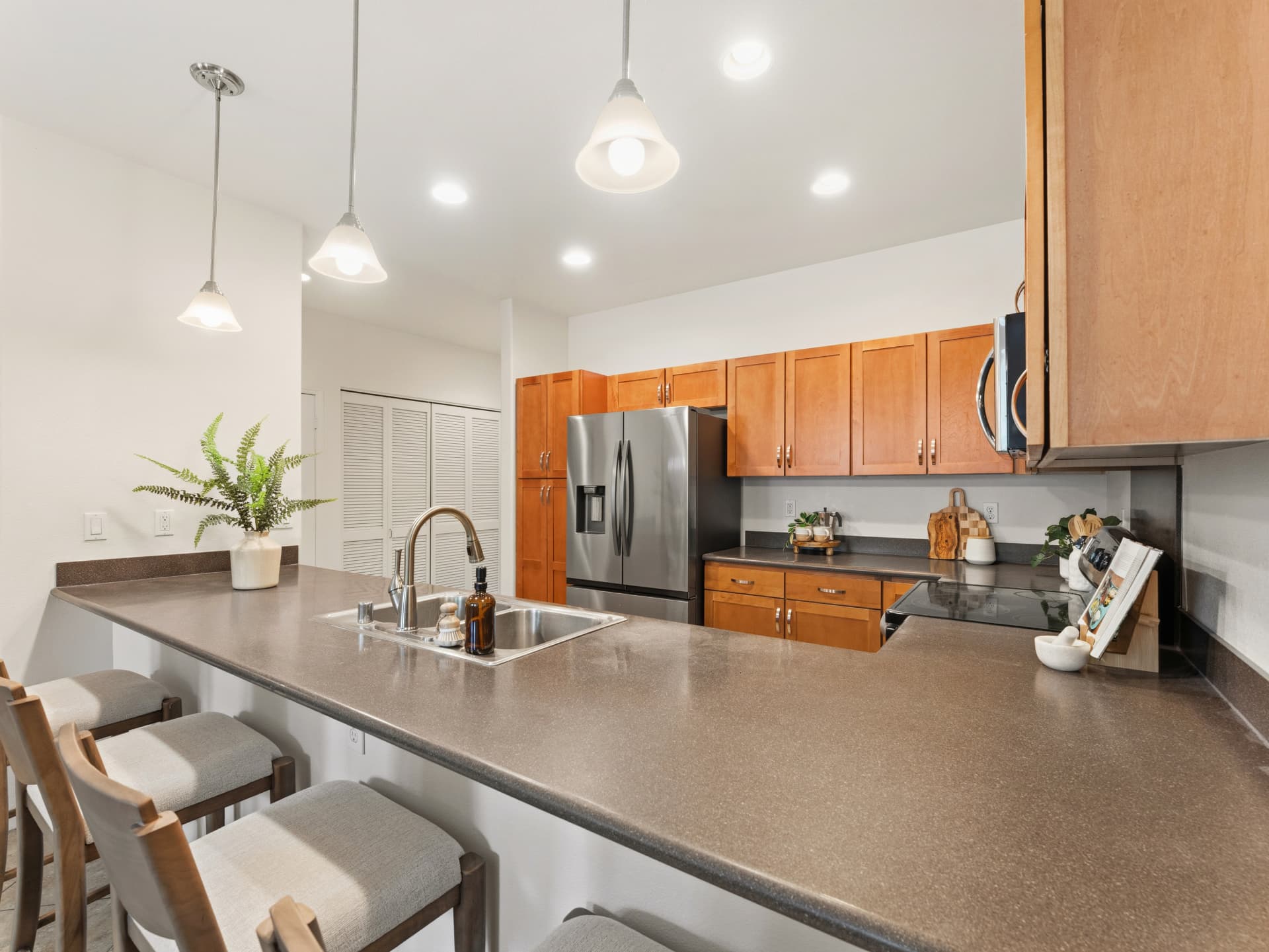 Kitchen with stainless steel appliances and breakfast bar