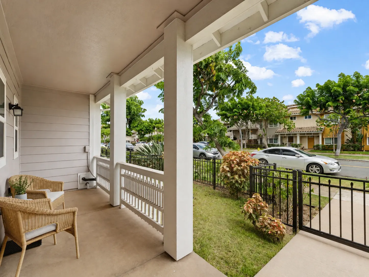 Front lanai seating area overlooking the tree-lined street