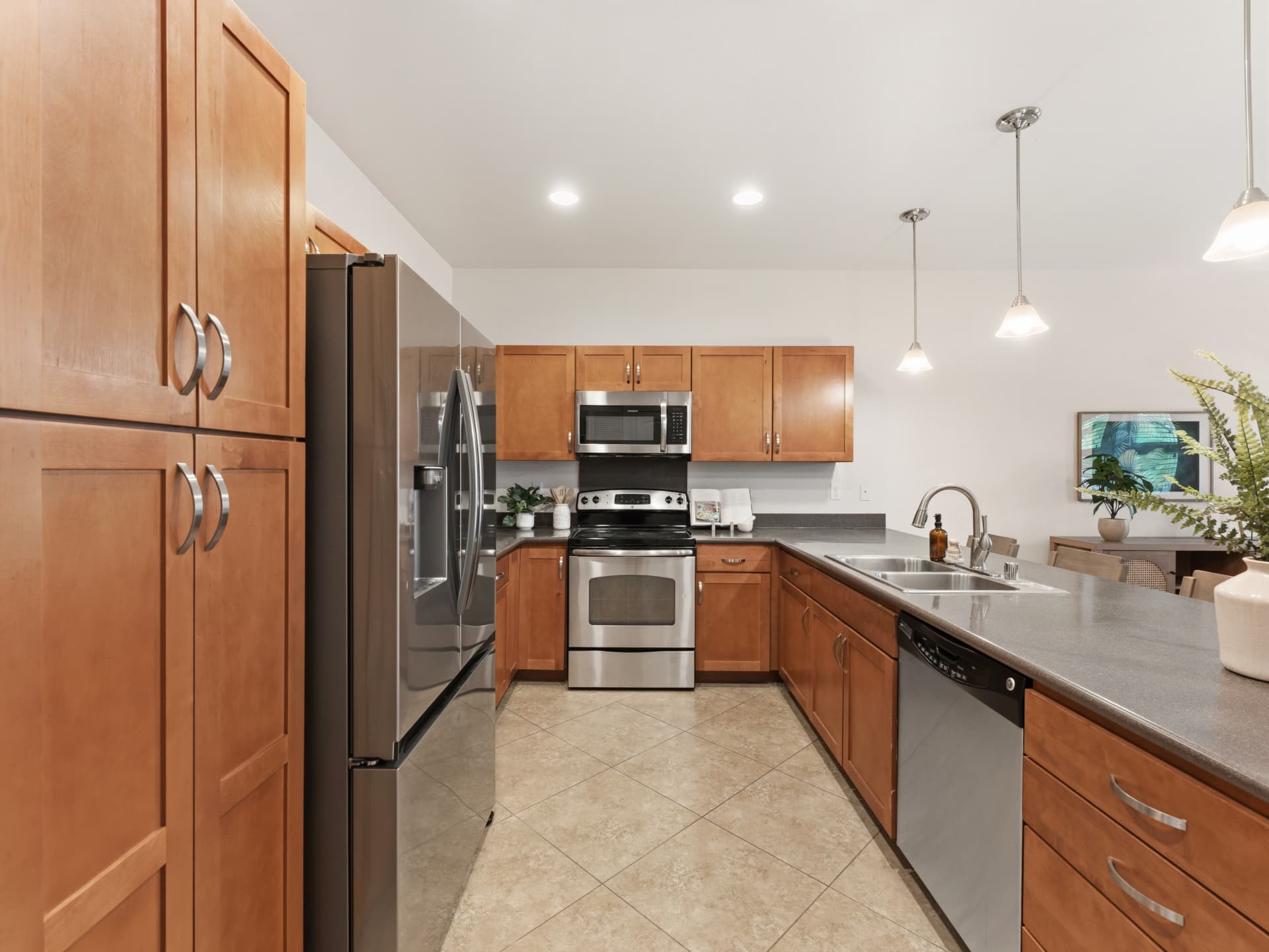Kitchen looking toward the dining area with pendant lighting