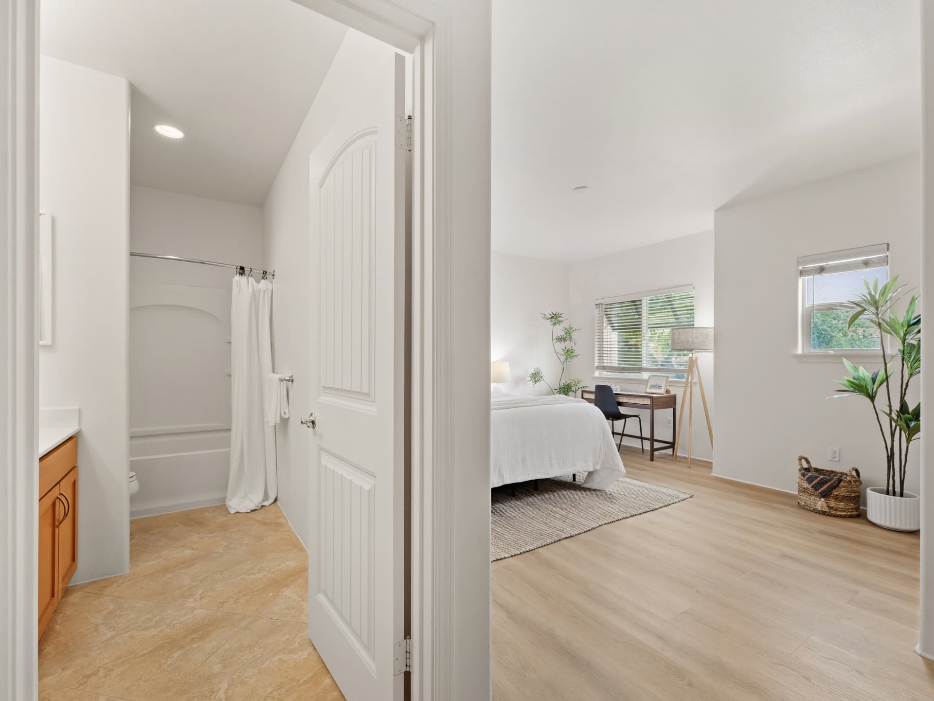Primary bath with tub-shower adjoining the bedroom